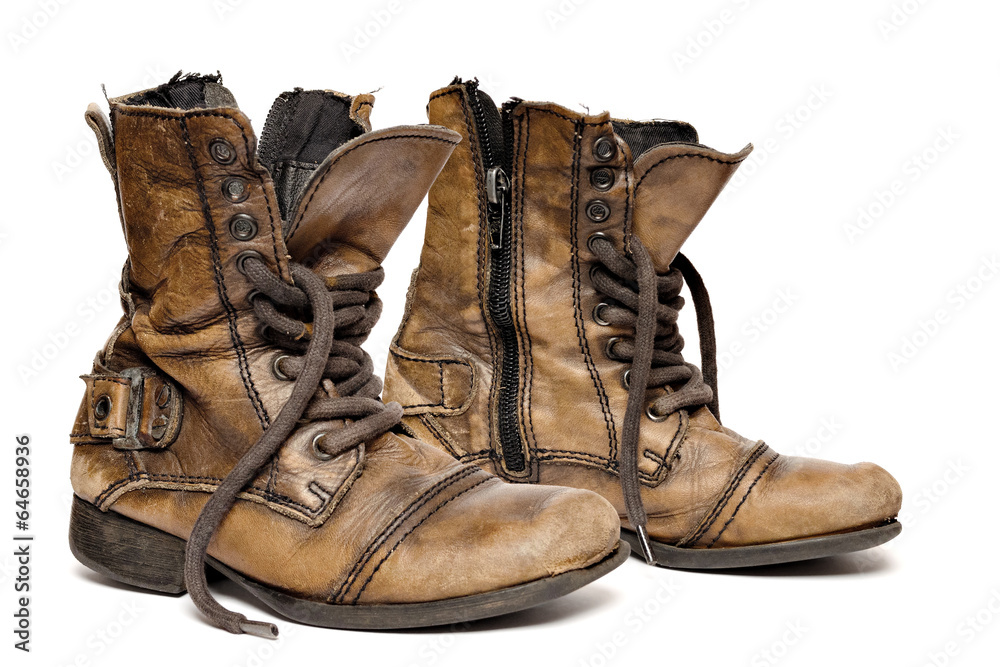 Pair of an old boots isolated on white background. Stock Photo | Adobe Stock