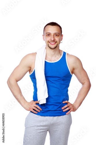 Happy sportive man with towel standing over white background