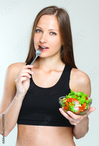 woman eating vegetables salad.