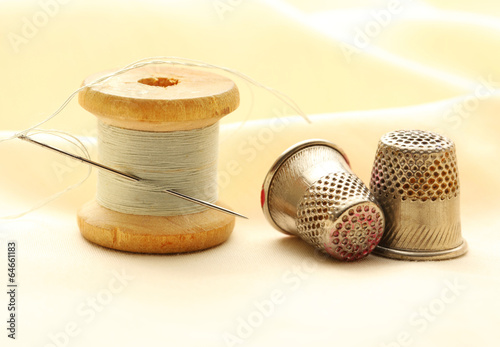 Sewing thimbles, bobbin and needle