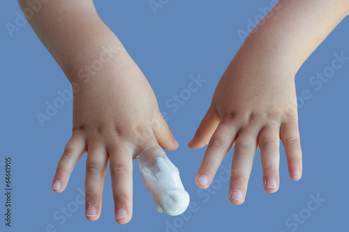 Hands of a child with bandaged index finger