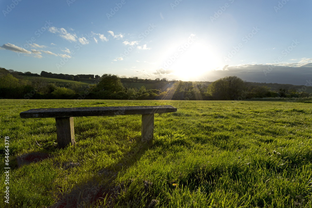 Sunlight over a bench on grass Sunlight over a bench on grass