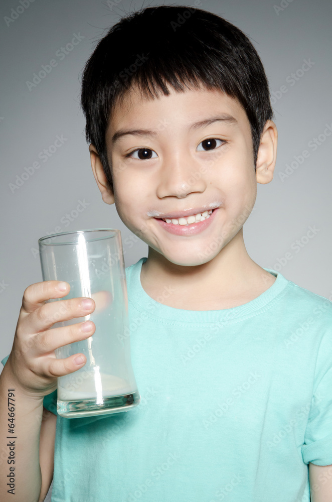 Portrait of Little asian boy drinking a glass of milk Portrait of Little asian boy drinking a glass of milk