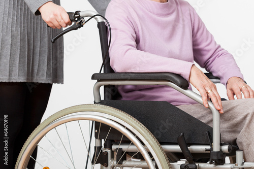 Lady on wheelchair and her guardian