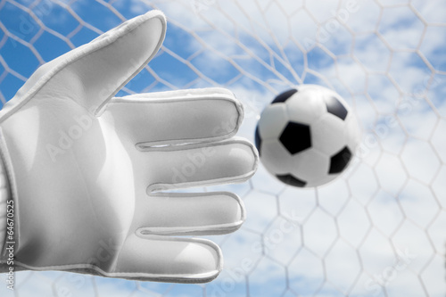 Goalkeeper's hands fail catching the soccer ball with net and bl