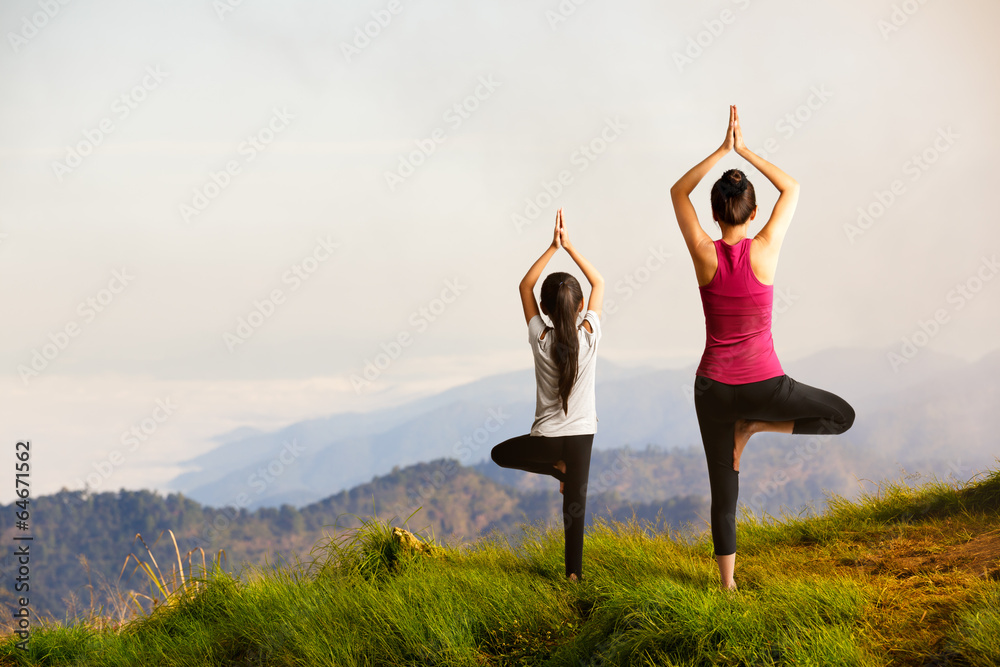 Mother and daughter doing yoga