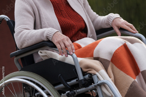 Elderly lady on wheelchair outdoors
