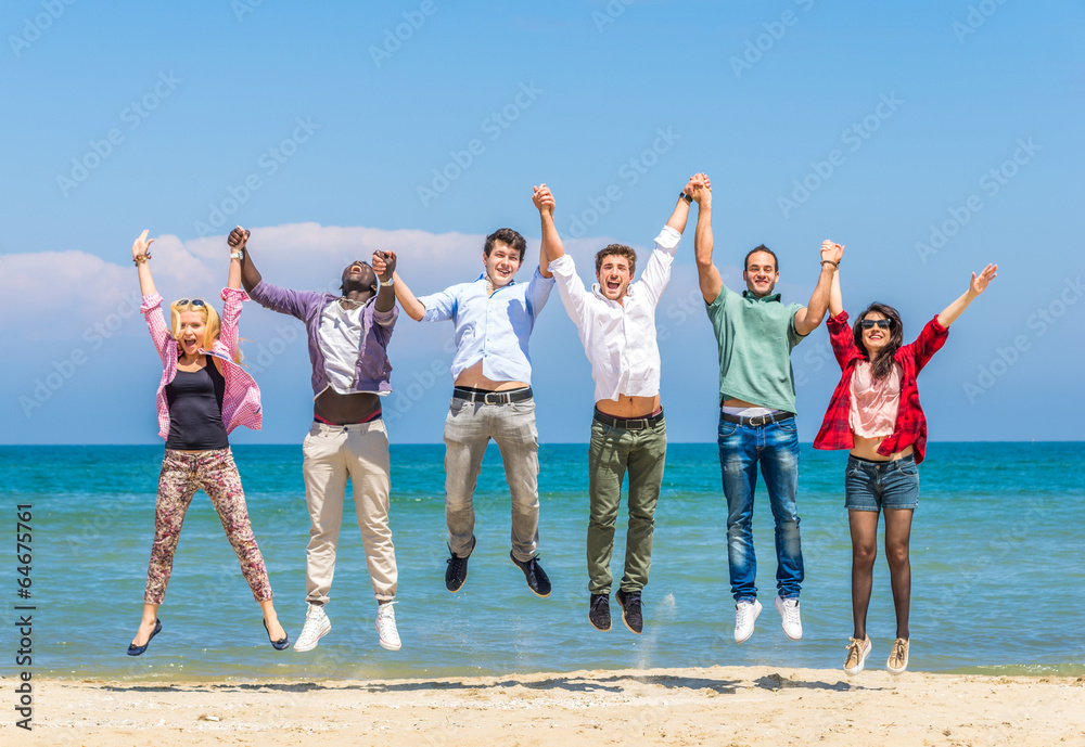 Friends jumping on the beach