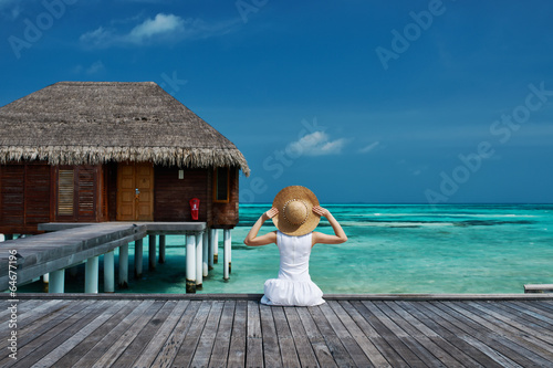 Woman on a beach jetty at Maldives