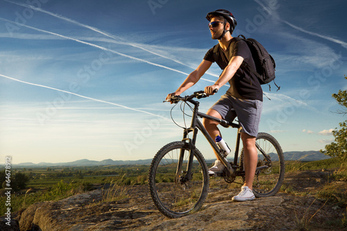 Fototapeta Naklejka Na Ścianę i Meble -  Young man riding mountain bike