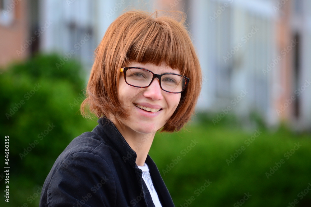 young woman with glasses smiling