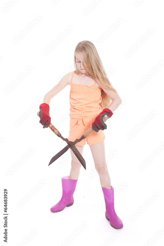 young blond girl with garden shears in studio young blond girl with garden shears in studio