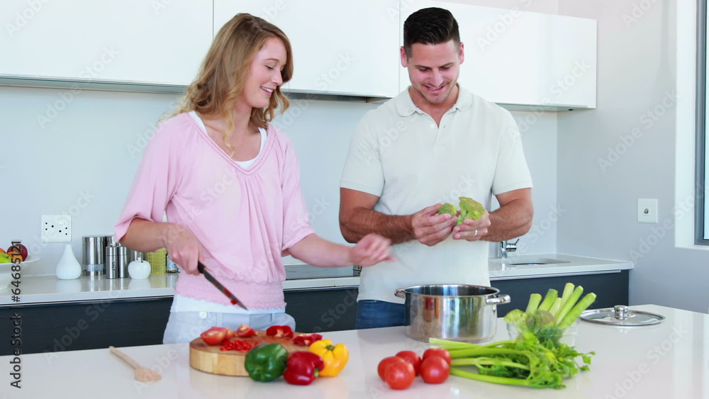 Smiling couple preparing a healthy dinner together Smiling couple preparing a healthy dinner together