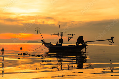 Canvas Print Silhouette of boat in sea at sunset