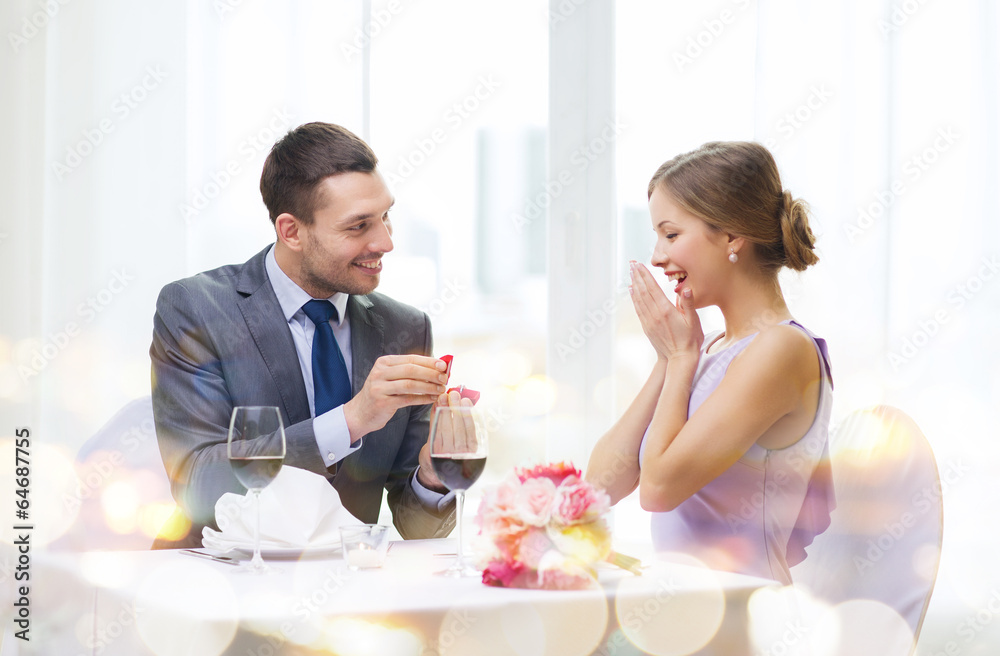 man proposing to his girlfriend at restaurant man proposing to his girlfriend at restaurant