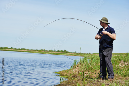 Fisher fishing fish with rod