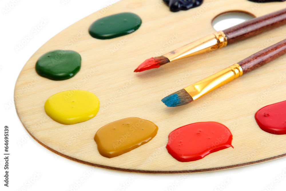 wooden art palette with paint and brushes.isolated on white wooden art palette with paint and brushes.isolated on white