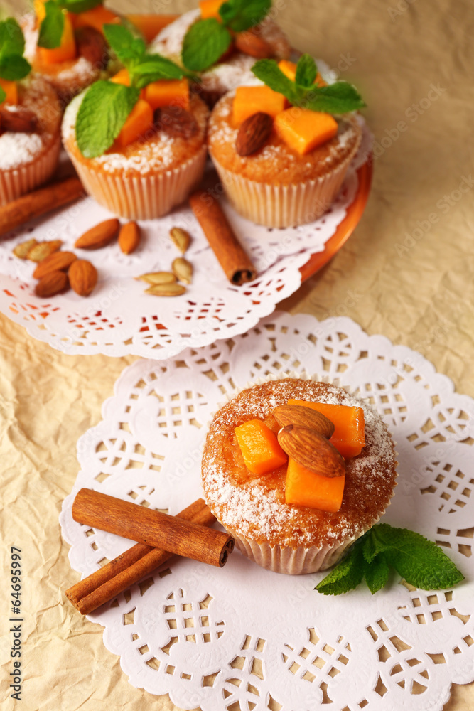 Tasty pumpkin muffins on brown paper Tasty pumpkin muffins on brown paper