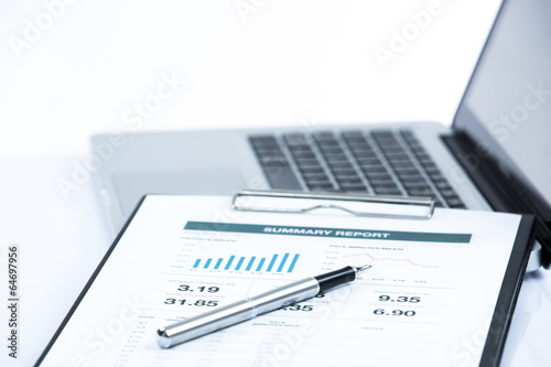 Businessman analyzing investment charts on laptop