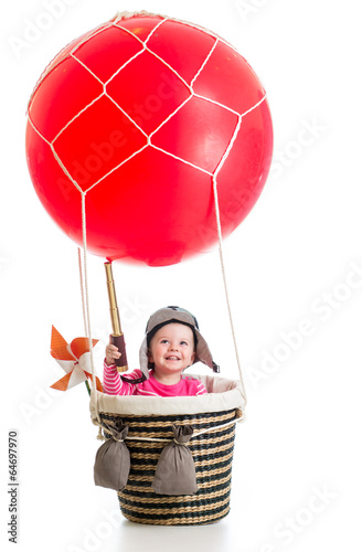 child with pilot hat and te...