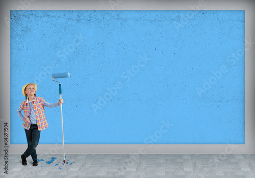 girl in a hat with a roller for painting