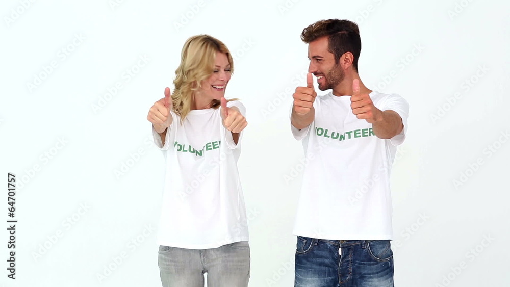 Two volunteers giving thumbs up to camera Two volunteers giving thumbs up to camera