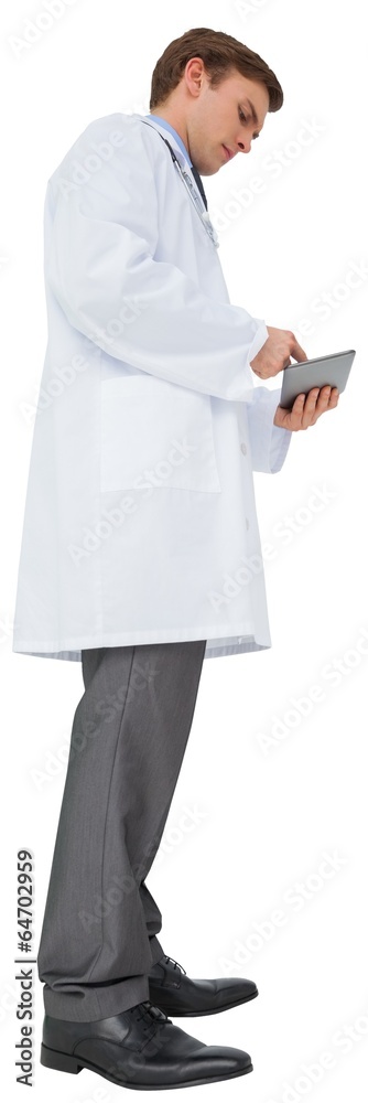 Young doctor in lab coat using tablet pc Young doctor in lab coat using tablet pc