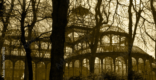 Antique glass building with trees in sepia tone