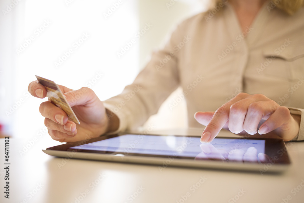 Woman shopping using tablet pc and credit card . online Woman shopping using tablet pc and credit card . online