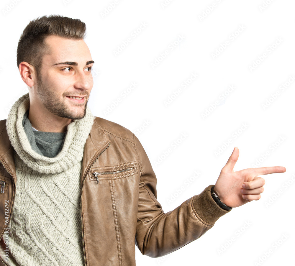 Young man pointing to his right over white background Young man pointing to his right over white background