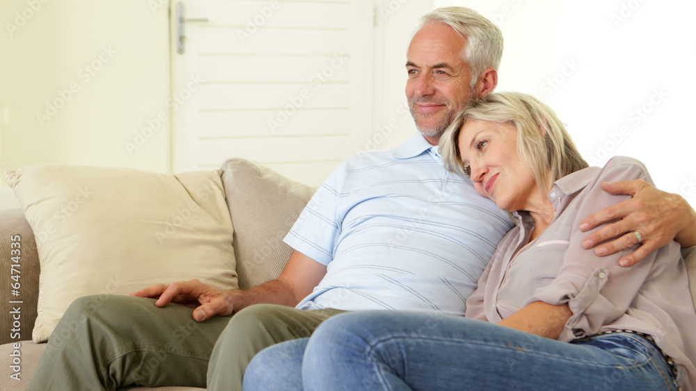 Couple relaxing together on the couch Couple relaxing together on the couch