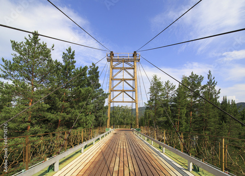 Suspension bridge on a mountain river Katun.