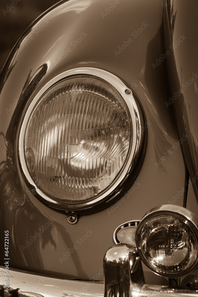 Headlamp vintage car close-up. Sepia.