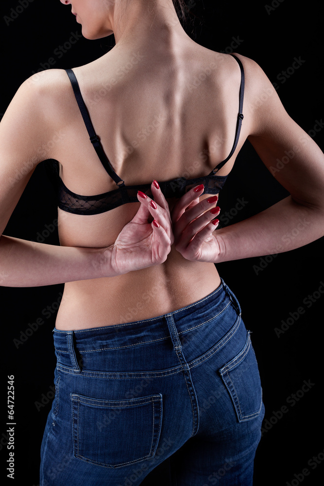 Woman unbuttoning her bra Stock Photo