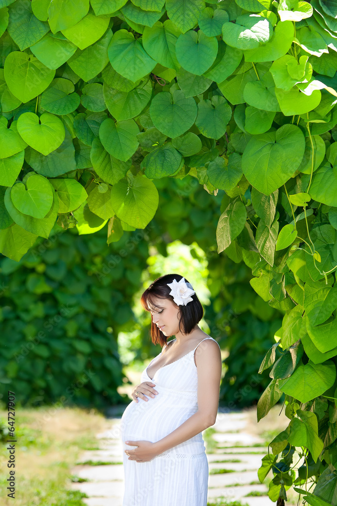 Pregnant caucasian woman takes rest outdoor Pregnant caucasian woman takes rest outdoor