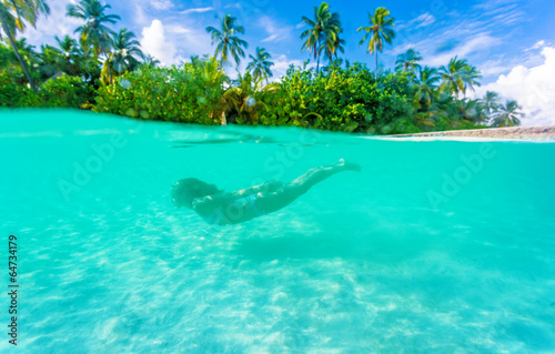 Female diving near exotic island