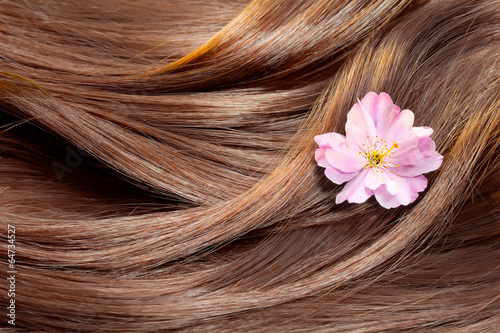 Beautiful healthy shiny hair texture with a flower