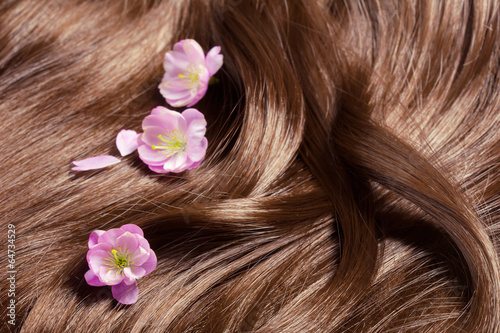 Beautiful healthy shiny hair with sakura flowers