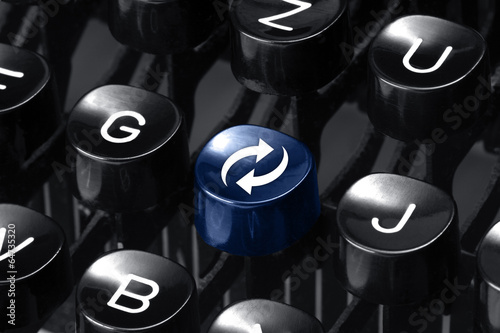 Synchronize. Blue hot key on an old typewriter
