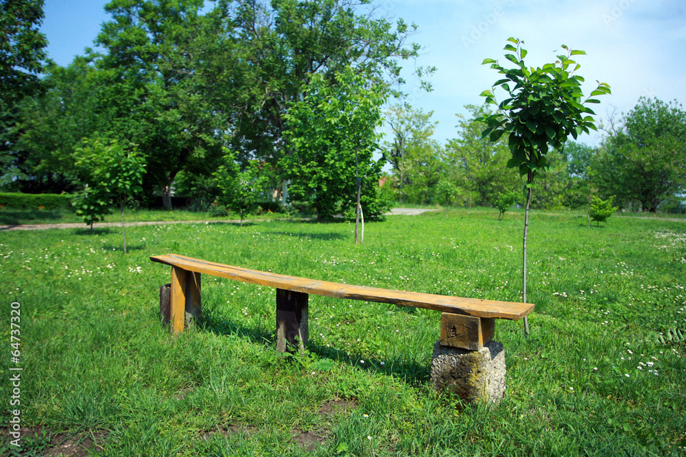 handmade old wooden bench in the green field handmade old wooden bench in the green field