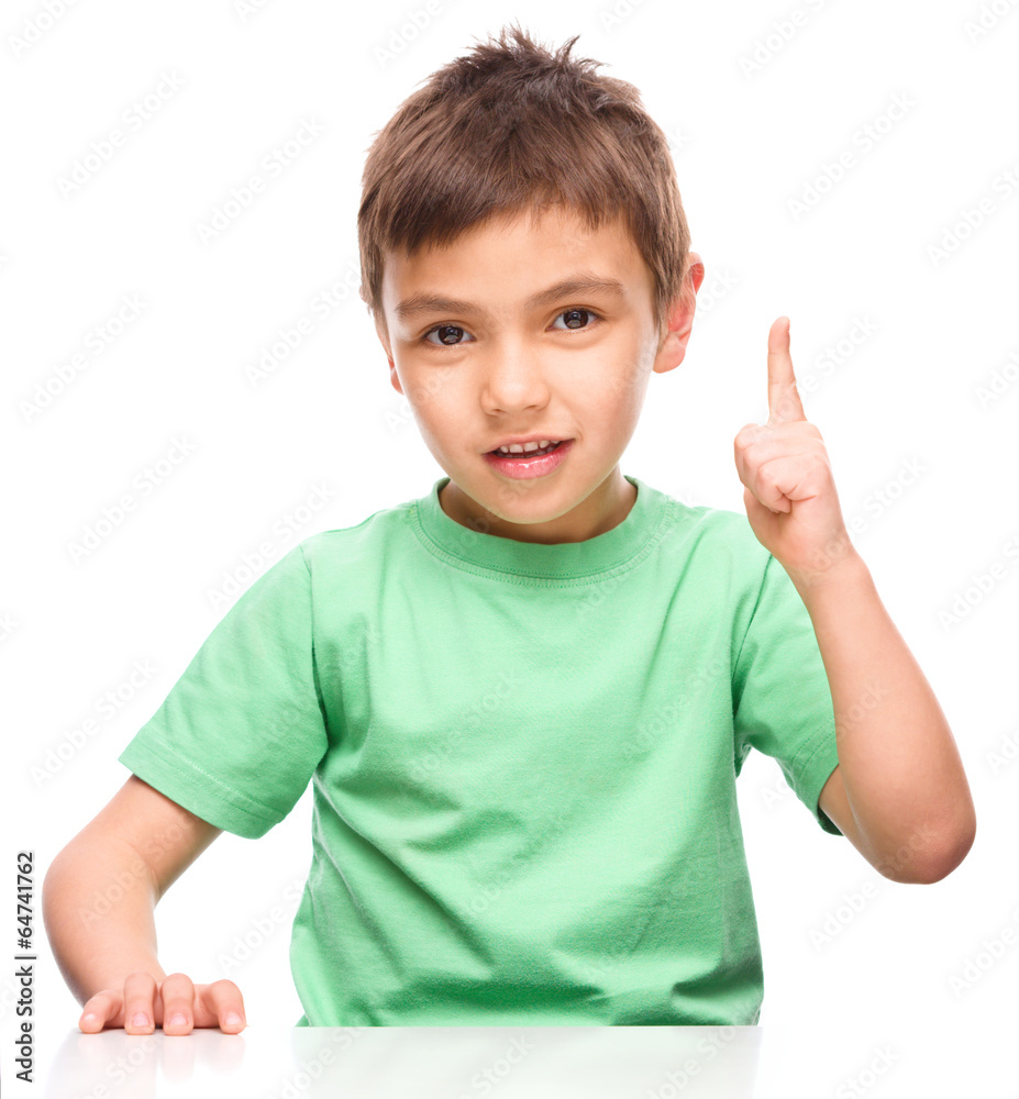 Little boy is pointing up using his index finger Little boy is pointing up using his index finger
