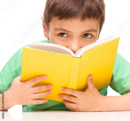 Little boy plays with book