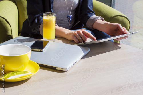 Woman using her mobile devices in cafe photo