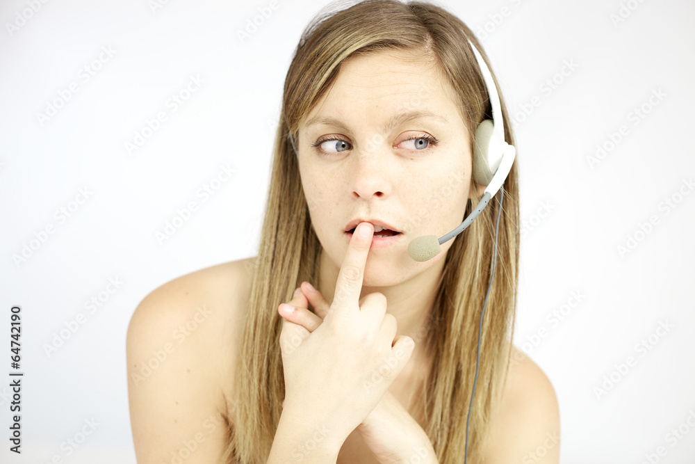 Nice young blond woman with headphones answering call Nice young blond woman with headphones answering call
