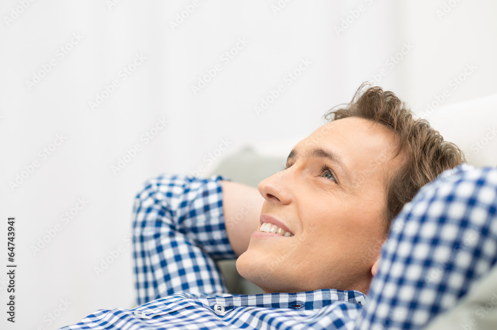 Happy Man Daydreaming On Sofa Happy Man Daydreaming On Sofa