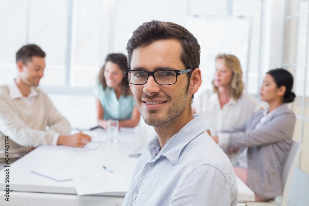 Casual businessman smiling at camera during meeting Casual businessman smiling at camera during meeting