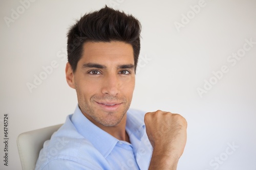 Casual businessman smiling at camera