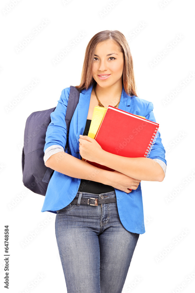 Female student carrying a backpack and notebooks Female student carrying a backpack and notebooks