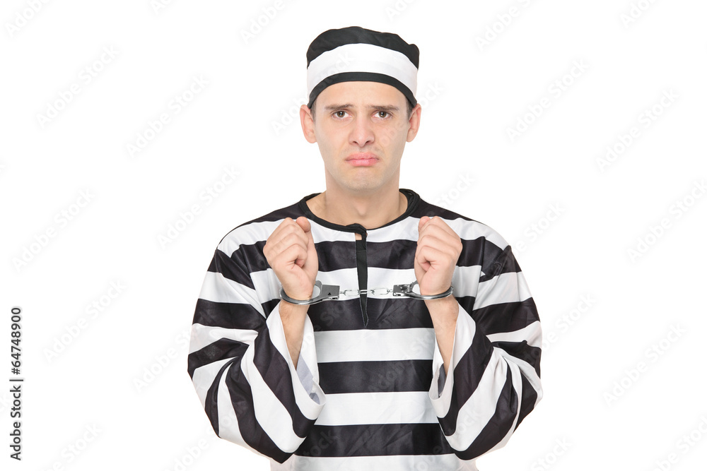 Sad male prisoner with handcuffs