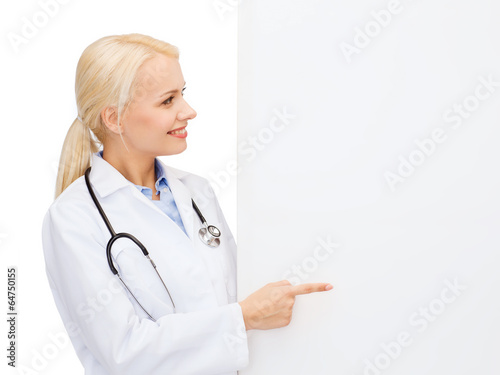 smiling female doctor with white blank board